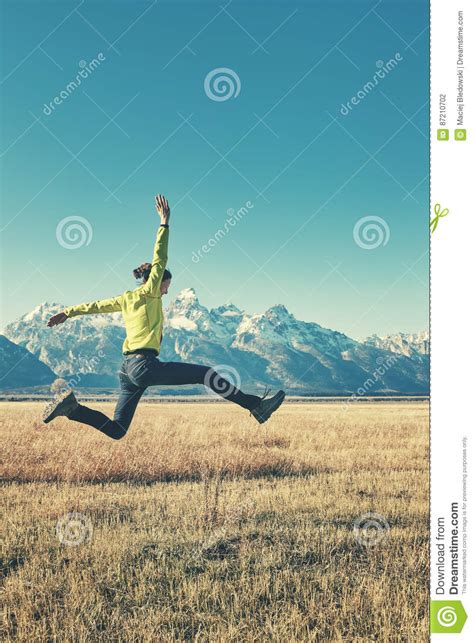 Retro Stylized Picture Of A Happy Young Woman Jumping