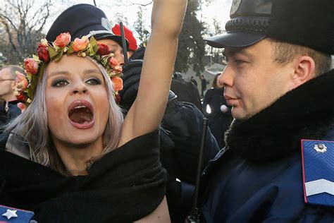 ukrainian policemen arrest an activist of the women s movement femen during their topless