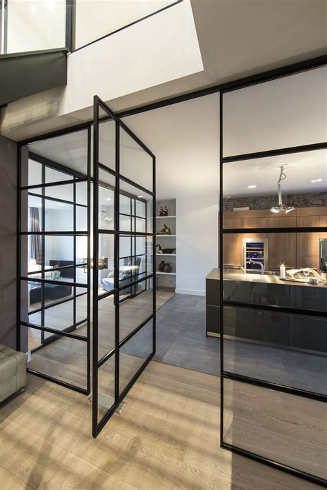 Black Framed Glass Doors Are A Prominent Feature Of This Apartment S Interior Design