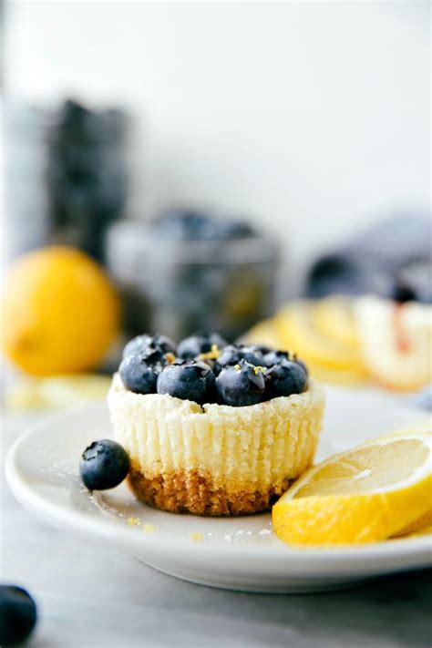 Miniature Sized Cheesecakes Flavored With A Hint Of Lemon Topped With Blueberry Jam And