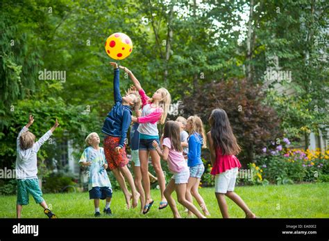 Children Playing Ball Game In Garden Stock Photo Alamy