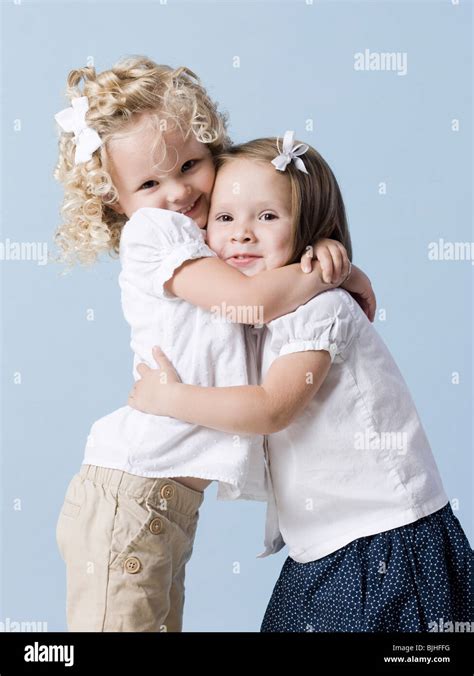 Two Little Girls Hugging Stock Photo Alamy