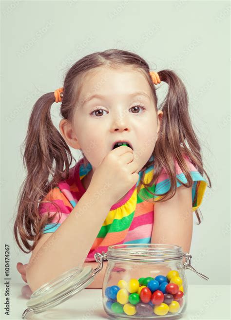 Beautiful Cute Little Girl Eating Candy From Candy Jar Photos Adobe Stock
