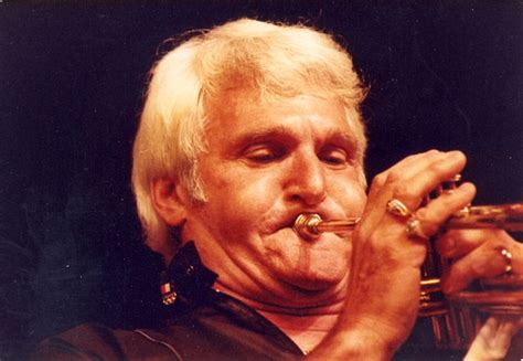 A Man With Blonde Hair Playing The Trumpet