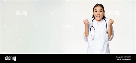 Enthusiastic Female Asian Doctor Celebrating Looking Hopeful And Happy At Camera Triumphing