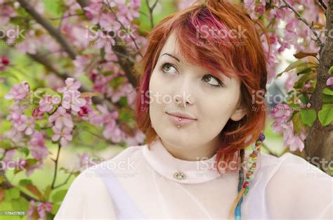 Front View Of Young Woman Looking Up Into Tree Stock Photo Download