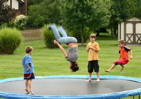 Kids On Trampoline Four Children Having A Great Time Jumping On