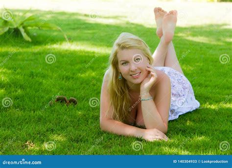 Young Blonde Beautiful Woman Laying At Grass Lawn In Summer Dress Stock Image Image Of Girl