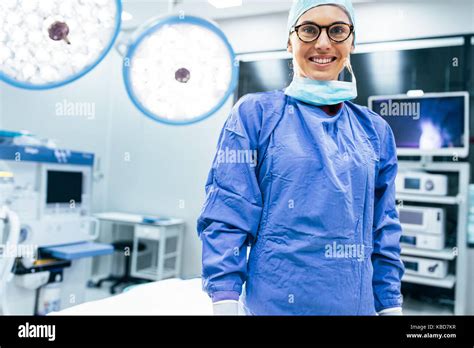 Portrait Of Smiling Female Surgeon In Surgical Uniform At Operating
