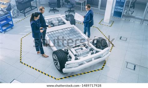 Automotive Design Engineers Talking While Working Stock Photo Edit Now