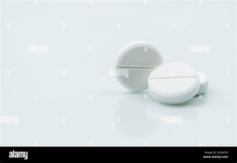 Macro Shot Of Three White Chewable Tablets On White Background With