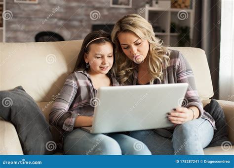 Modern Mother And Daughter Sitting On The Couch Stock Image Image Of Notebook Portrait 178287241