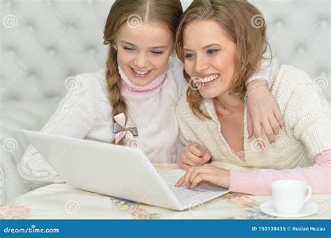 portrait of mother and daughter using laptop together stock image image of girl resource