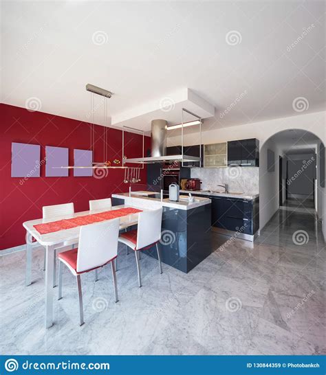 Modern Kitchen With Island Marble Table And Leather Chairs Stock Image
