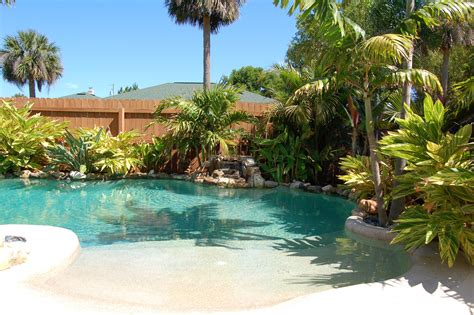 Pin By Statements By Design Garden On Pool Ideas Backyard Beach Tropical Pool Landscaping
