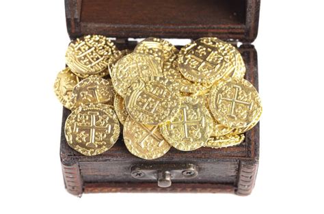 Treasure Chest Filled With Golden Coins On A White Background Stock