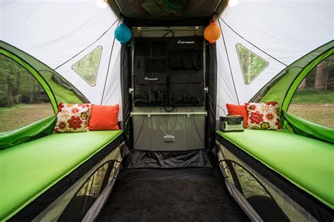 The Inside Of A Camper With Two Twin Beds And Pillows On Its Sides