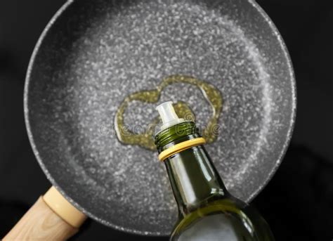 Pouring Olive Oil Onto Frying Pan On Stove Stock Photo Image Of