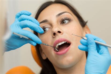 Pretty Girl Having Mouth Checkup In Hospital By Professional Female