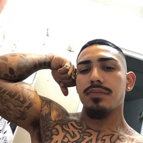 A Man With Tattoos On His Chest And Arm
