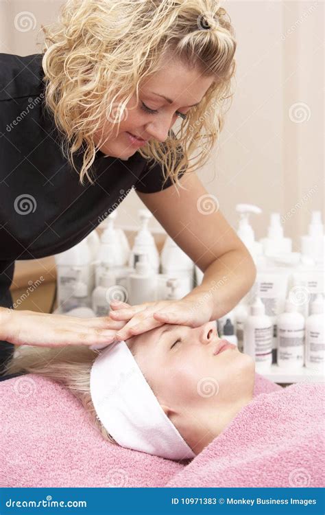 female masseuse giving client facial stock image image 10971383