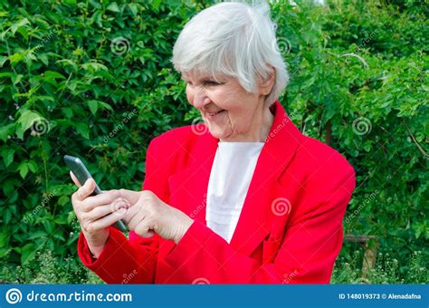 Portrait Of Old Lady Grandmother Makes Selfie Outdoors At Sun Day Modern Granny Finger Touch