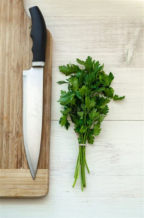Fresh Organic Parsley With Knife On Wooden Cutting Board Stock Image