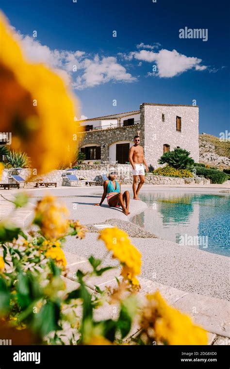 Couple On Luxury Vacation Relaxing By The Pool At An Agriturismo In Sicily Italy Mid Age Couple