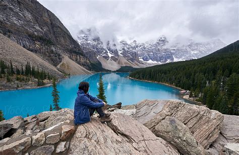 Woman Enjoying The Snowy Landscape And The Beauty Turquoise Moraine