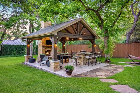 This Freestanding Covered Patio With An Outdoor Kitchen And Fireplace