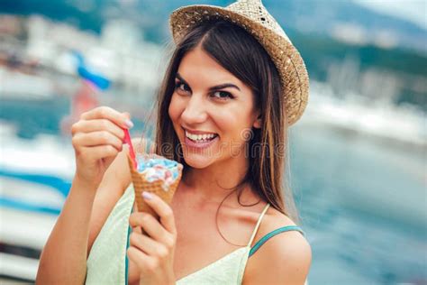 Woman Eating Ice Cream Outside On Summer Vacation In Holiday Resort