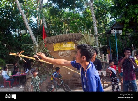 A Man Is Adjusting A Pulley Before A Traditional Khmer New Year Game At