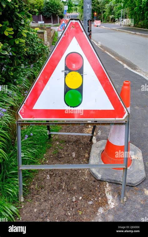 Traffic Lights Warning Triangle Sign On Road In Uk Stock Photo Alamy