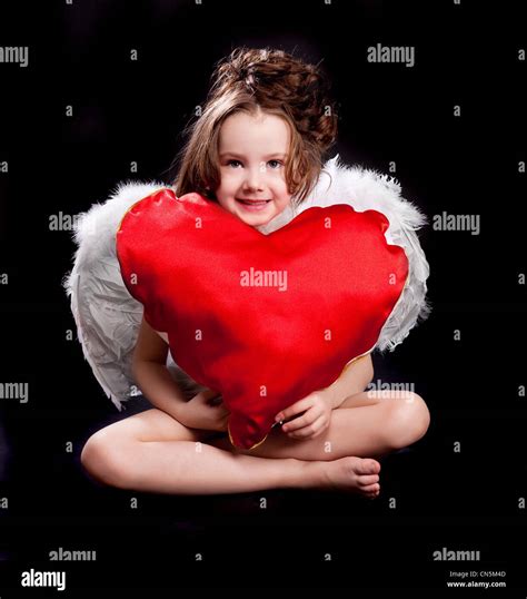 Cute Six Year Old Girl With White Wings And A Big Heart Isolated