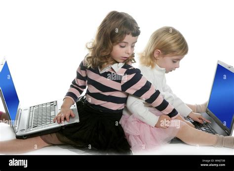 Two Little Girls Sister Studying Computer Laptops At School Stock Photo