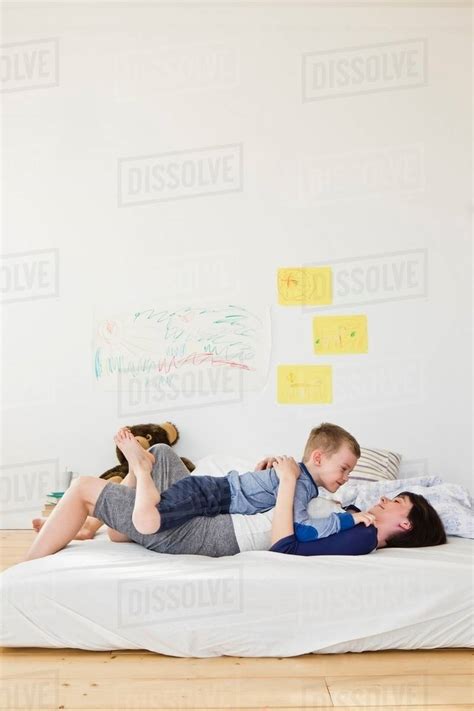 Mother And Son Relaxing On Bed Stock Photo Dissolve