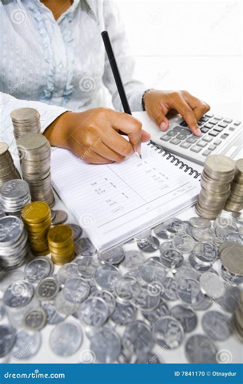 Woman Working On Accounting With Many Coins Around Stock Photo Image