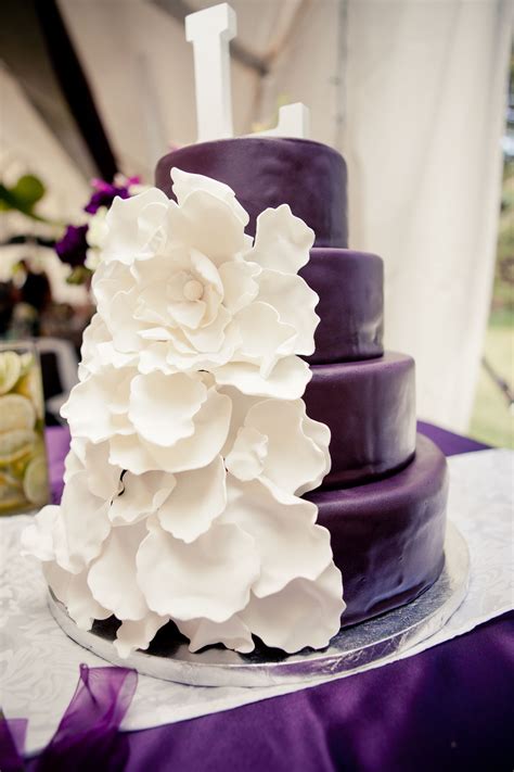 elegant purple wedding cake with white flower accents