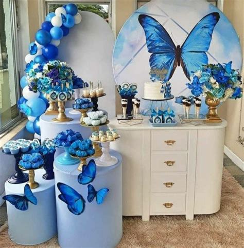 A Blue And White Dessert Table With Butterfly Decorations