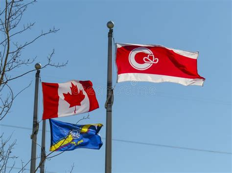 A Calgary Flag Next To A Canada Flag With A Calgary Fire Department