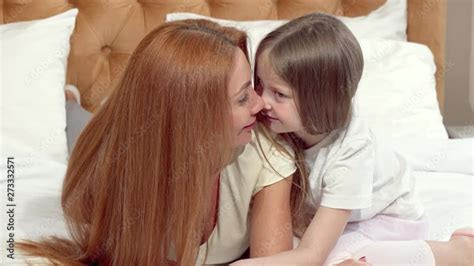 Vid O Stock Happy Mother And Daughter Rubbing Noses Resting At Home