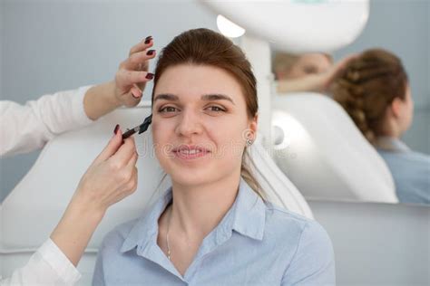 Make Up In A Beauty Salon The Model Looks Into The Camera Stock Image