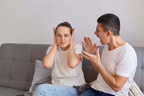 Indoor Shot Of Young Couple Having Conflict Angry Fury Man Sitting On