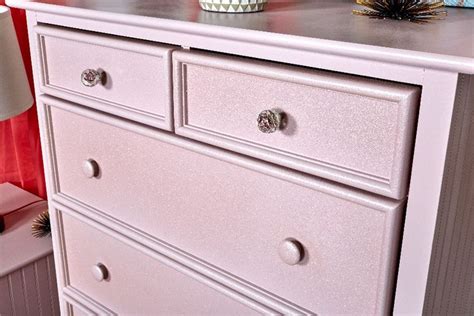 A White Dresser With Drawers In A Room