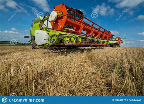 Combine Harvester Close Up In Wheat Field Harvesting Focus On The