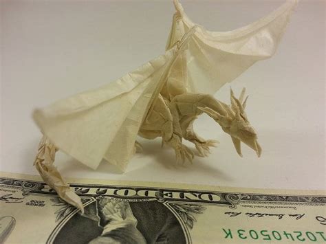 An Origami Dragon On Top Of One Dollar Bill