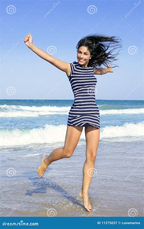 beautiful brunette girl jumping on the beach stock image image of active blue 11275037