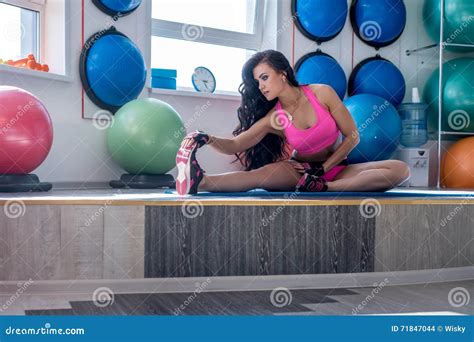 Brunette Doing Stretching Exercise In Fitness Room Stock Photo Image