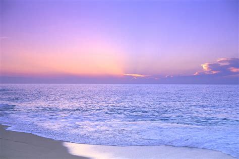 Lavender Sky With Hues Of Pink And Yellow Shoreline Water To Ocean