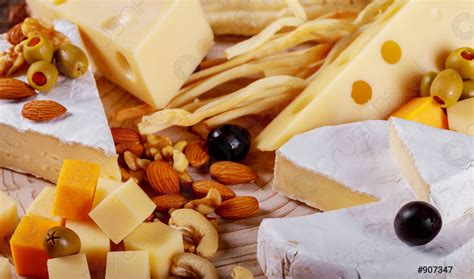 Large Assortment Of International Cheese Specialities On Wood